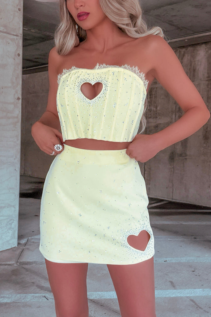 Model wearing rhinestone heart cut-out top