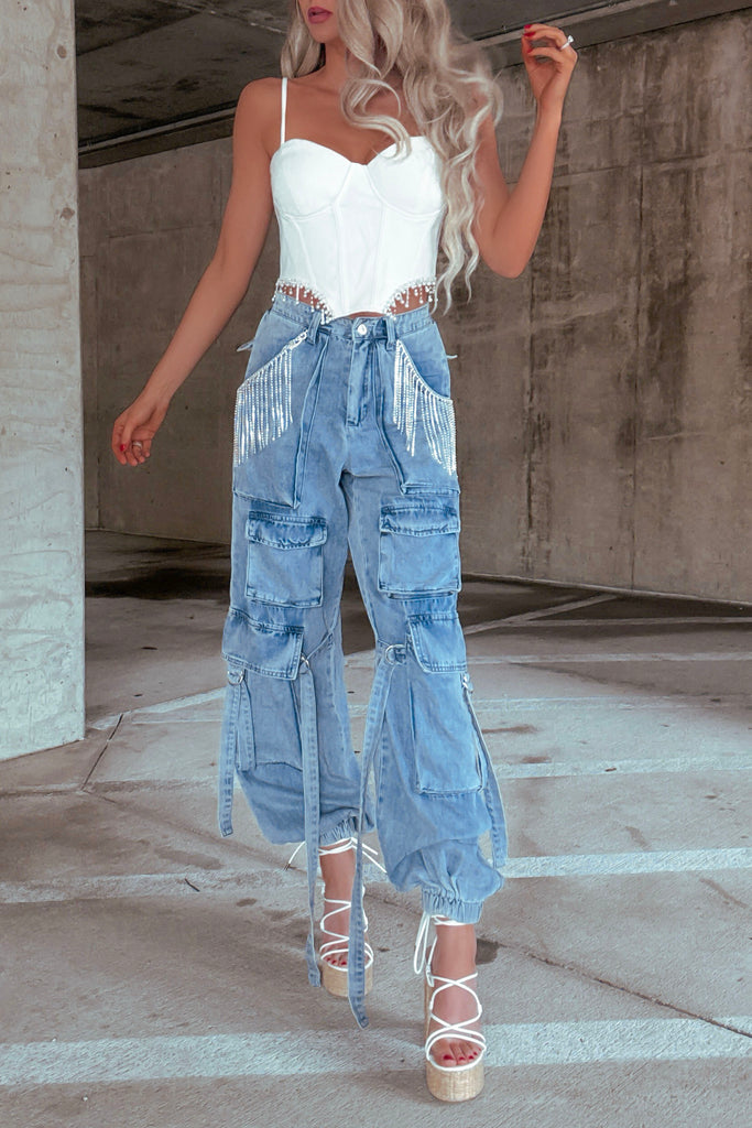 Model wearing rhinestone denim fringe joggers